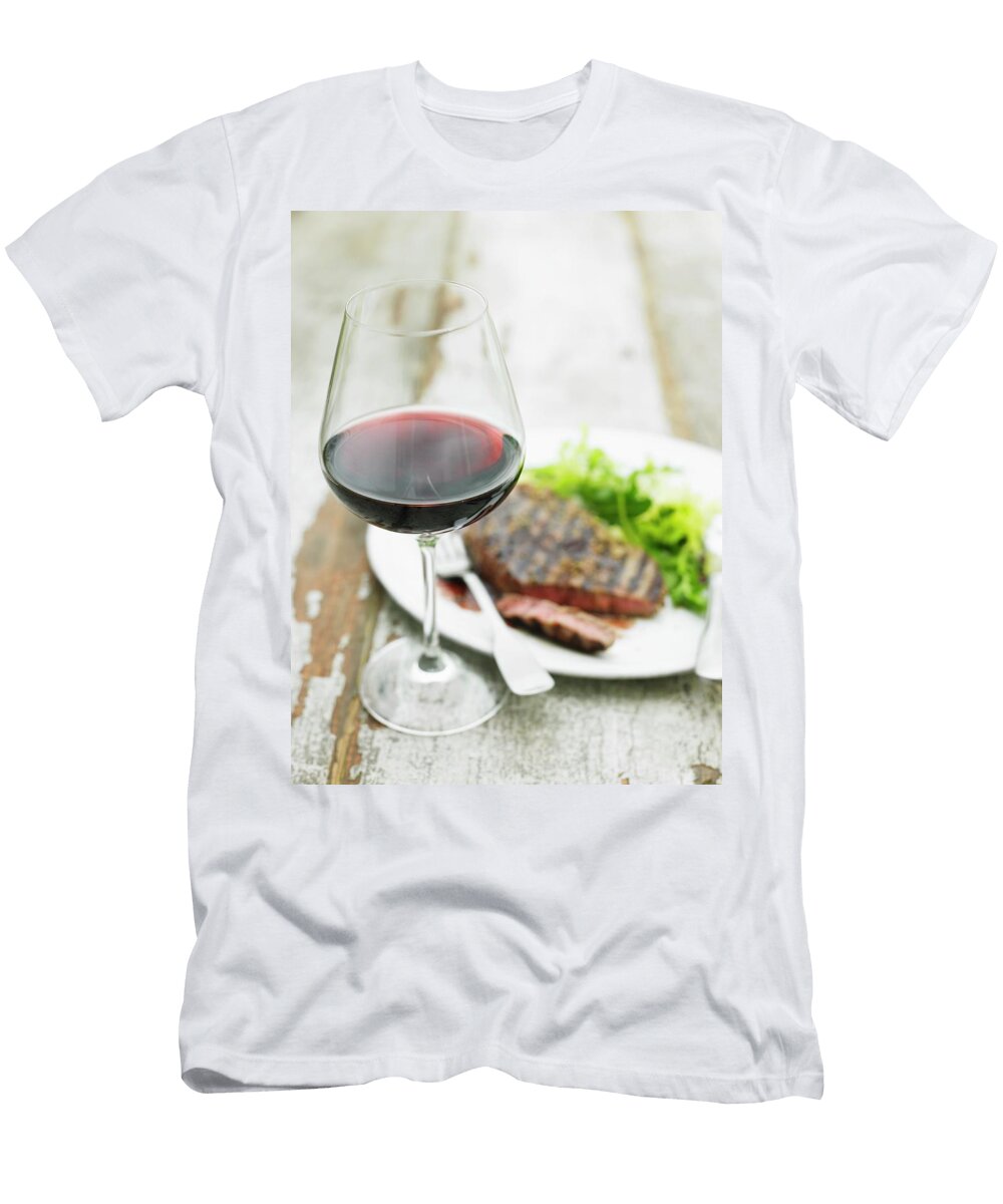 A Glass of Red Wine in Front of a Grilled Beef Steak with Salad Myles New T-Shirt