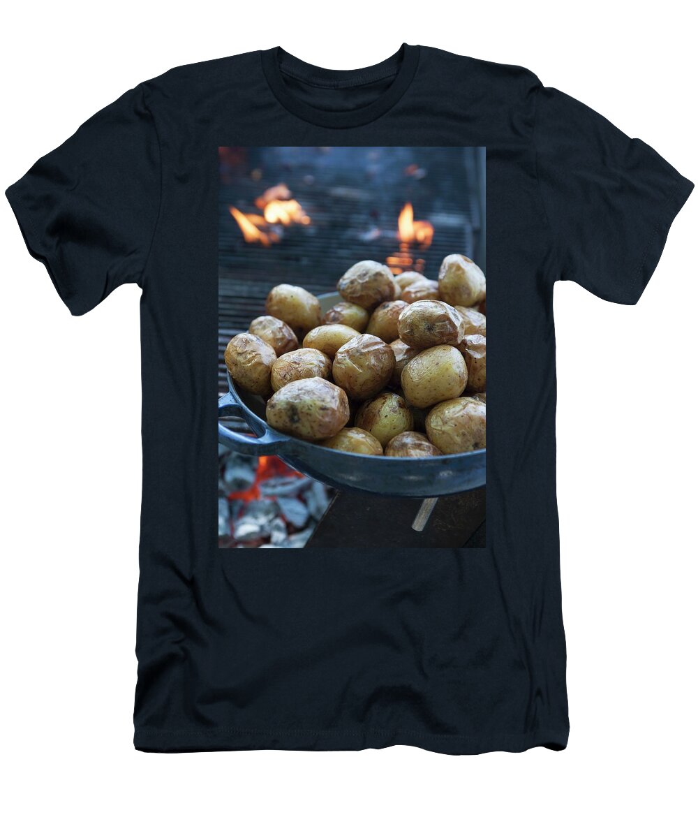 A Pan of Baked Potatoes in Front of a Glowing Grill Joerg Lehmann T-Shirt