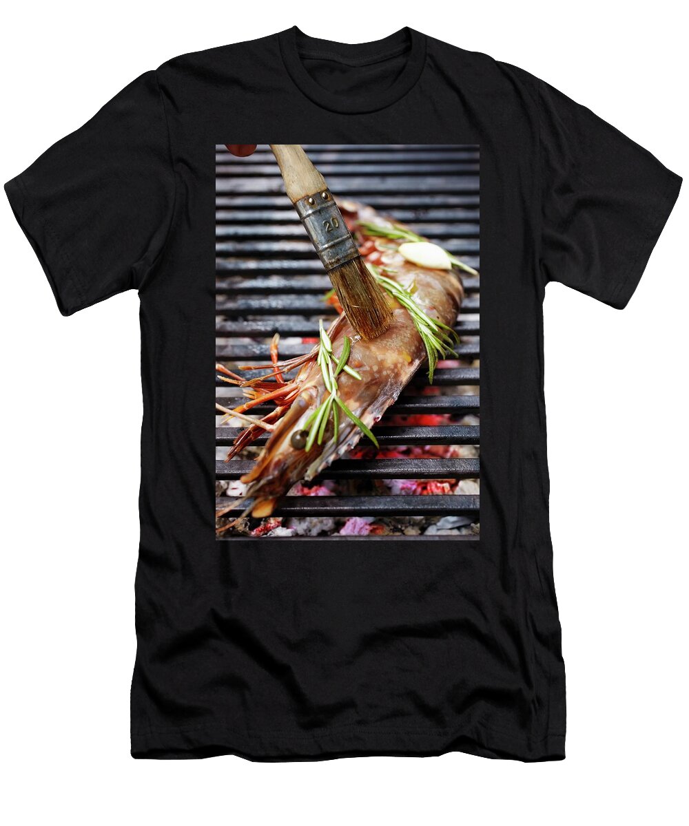 A Rosemary Flavoured King Prawn Being Brushed on a Grill Jalag Jan C Brettschneider T-Shirt