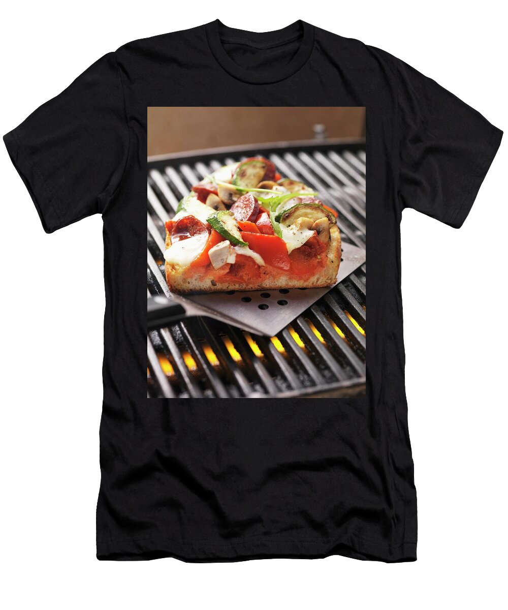 A Slice of Sausage Vegetable and Mozzarella Pizza Cooked on the Barbecue on a Spatula Eising Studio Food Photo Video T-Shirt