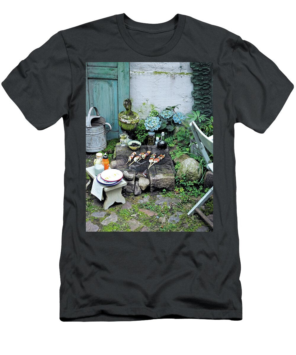 Five Chicken Skewers on Grill Rack on Bricks with Olives in Bowl in Garden Jalag Wolfgang Kowall T-Shirt