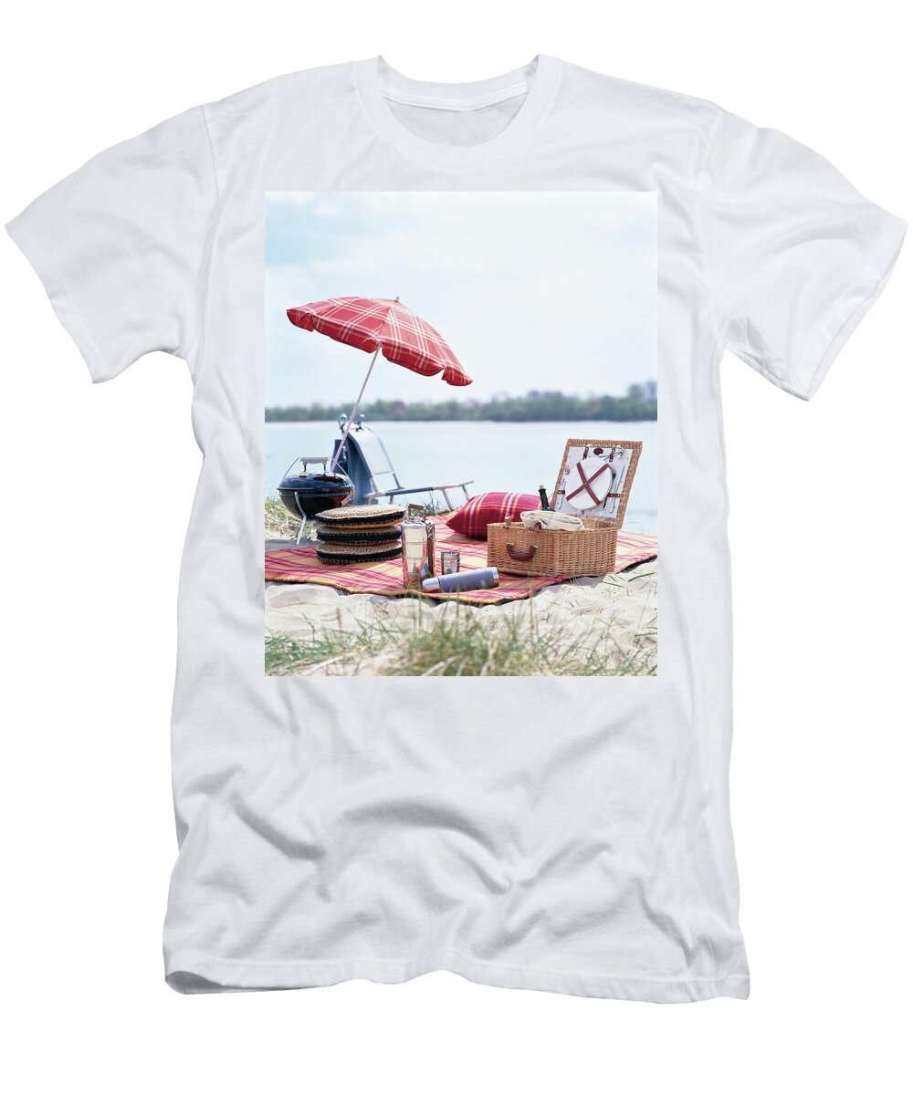 Picnic Accessories Picnic Basket and Umbrella Laid on Picnic Blanket At Lake Jalag Andr Reuter T-Shirt