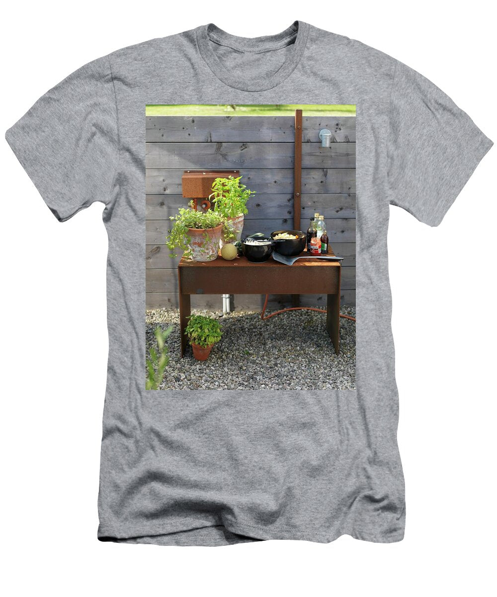 Potted Herbs and Bowls on Rustic Metal Side Table Against Wooden Fence on Gravel Floor Outdiirs Peter Carlsson T-Shirt