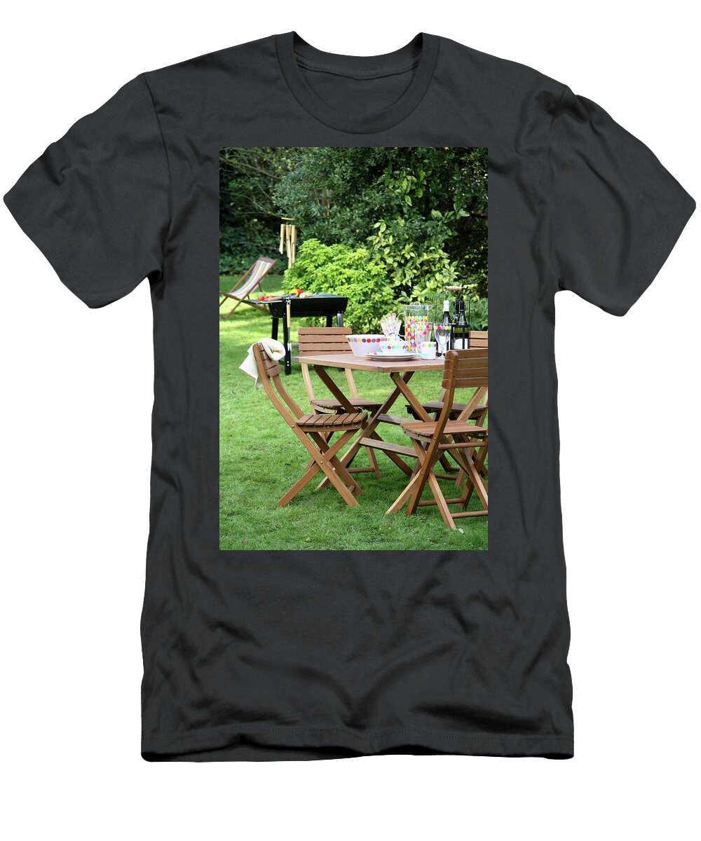 Set Table in Garden with Chairs Barbecue in Background Simon Scarboro T-Shirt