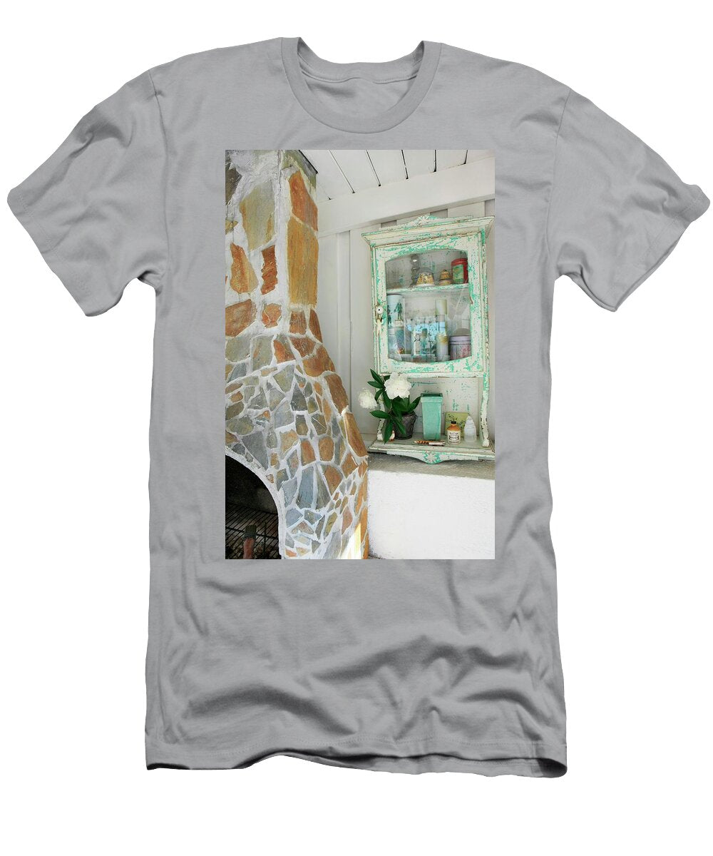 Stone Clad Fireplace and Chimney Breast Next to Small Vintage Cabinet Mounted on White Wooden Wall Annette Nordstrom T-Shirt